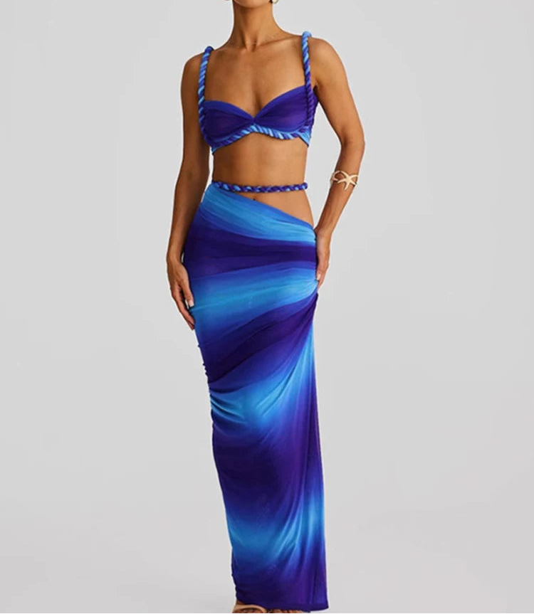 Woman wearing a blue and purple gradient dress on a gray background