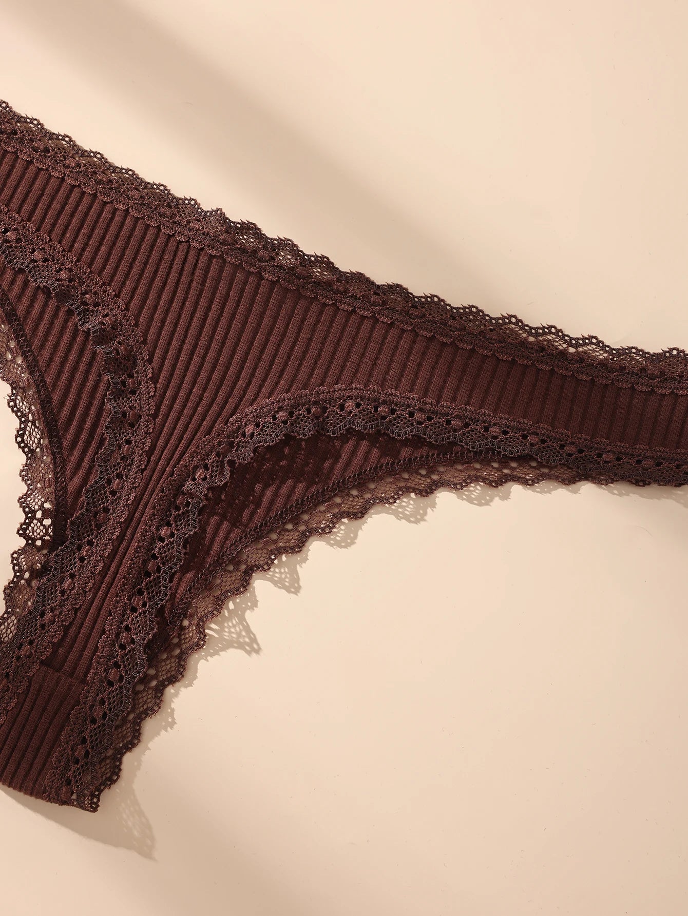 Brown lace lingerie on a beige background