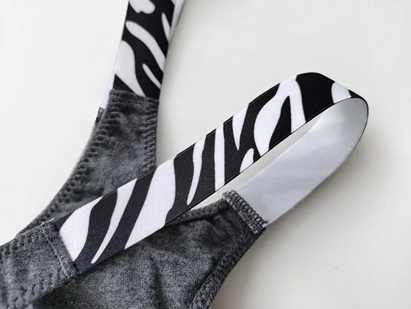 Close-up of a gray G-string thong with zebra-print side straps.