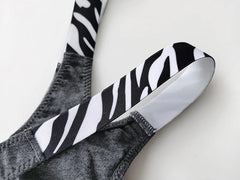Close-up of a gray G-string thong with zebra-print side straps.