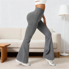 Person wearing gray ribbed pants in a living room setting