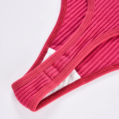 Close-up of red ribbed thong fabric and stitched gusset edges