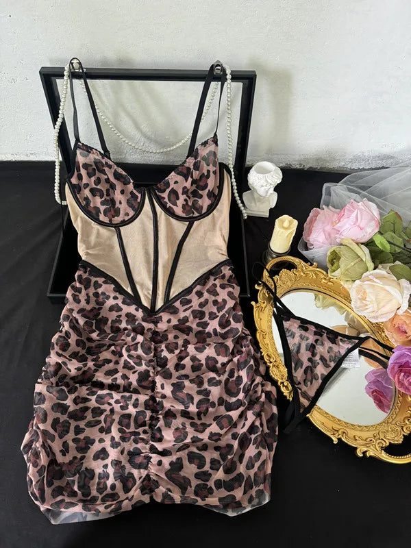 Leopard print lingerie set on a black stand with decorative items in the background.
