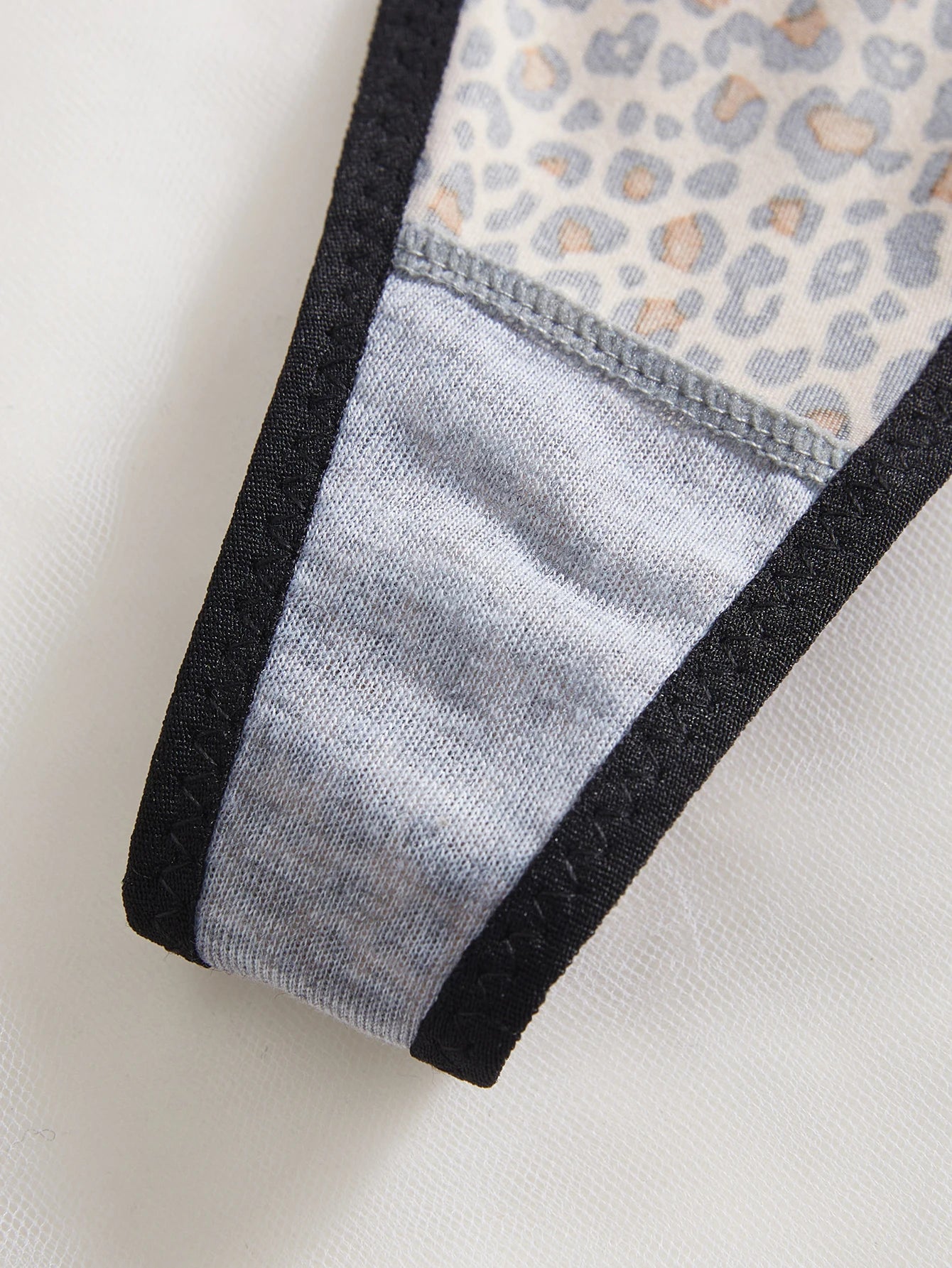 Close-up of a fabric edge with leopard print pattern on a white background