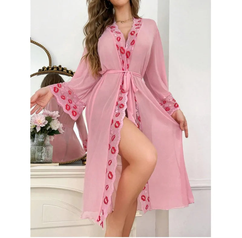 Pink robe with red floral patterns worn by a model in a decorative room.