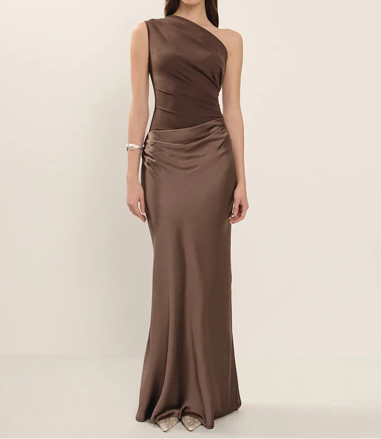 Woman wearing a brown one-shoulder dress on a beige background