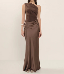 Woman wearing a brown one-shoulder dress on a beige background
