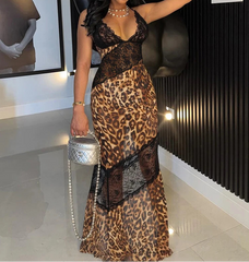 Woman in a leopard print dress posing indoors with a horse sculpture in the background