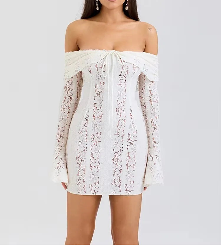 Woman wearing a white lace off-shoulder dress on a light gray background