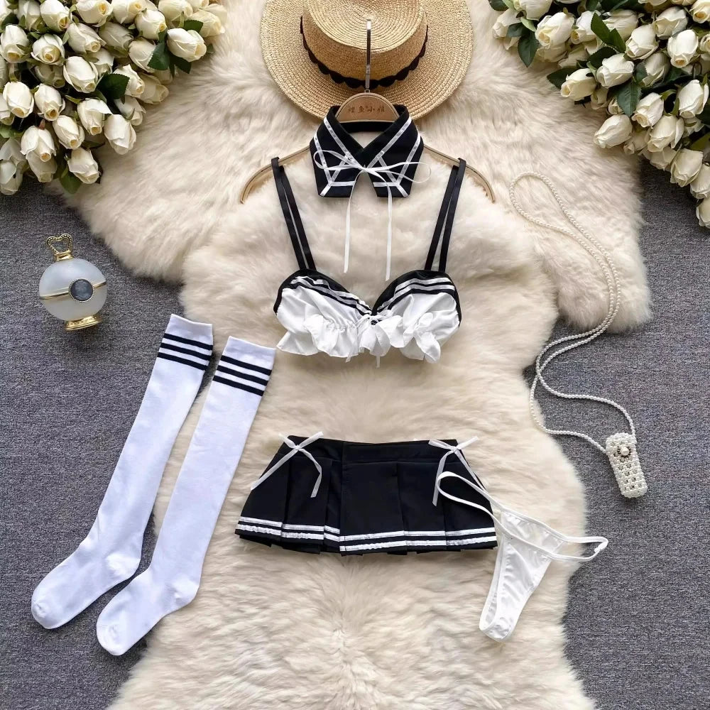 Black and white lingerie set with accessories on a fur surface with flowers around.