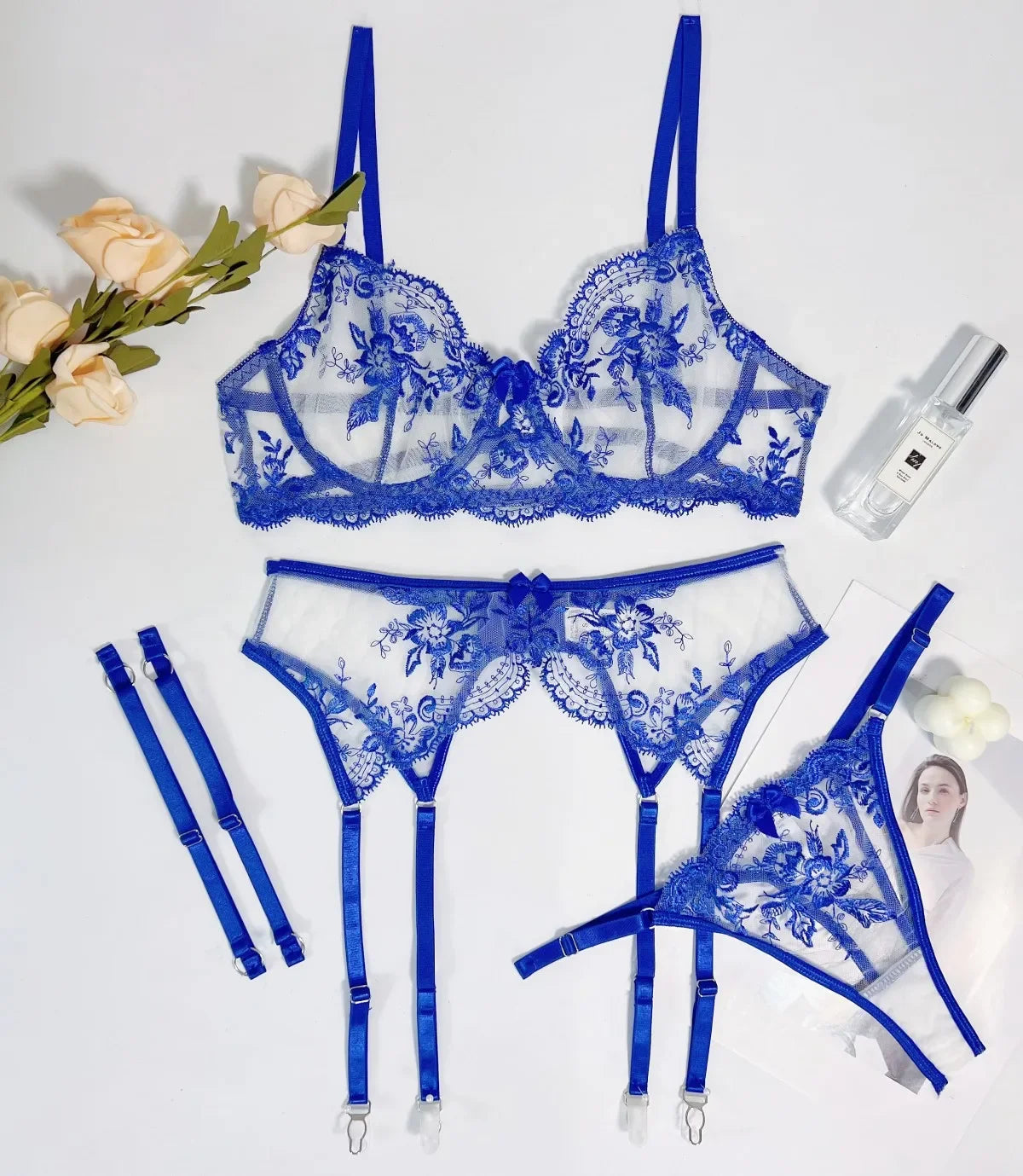 Blue lace lingerie set with floral designs on a white background.