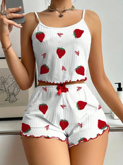 White romper with red strawberry pattern worn by a person, taking a mirror selfie.