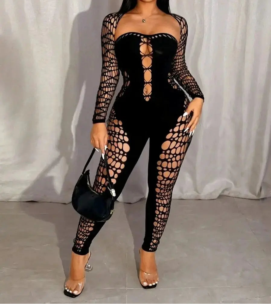 Woman wearing a black lace-up outfit against a plain background