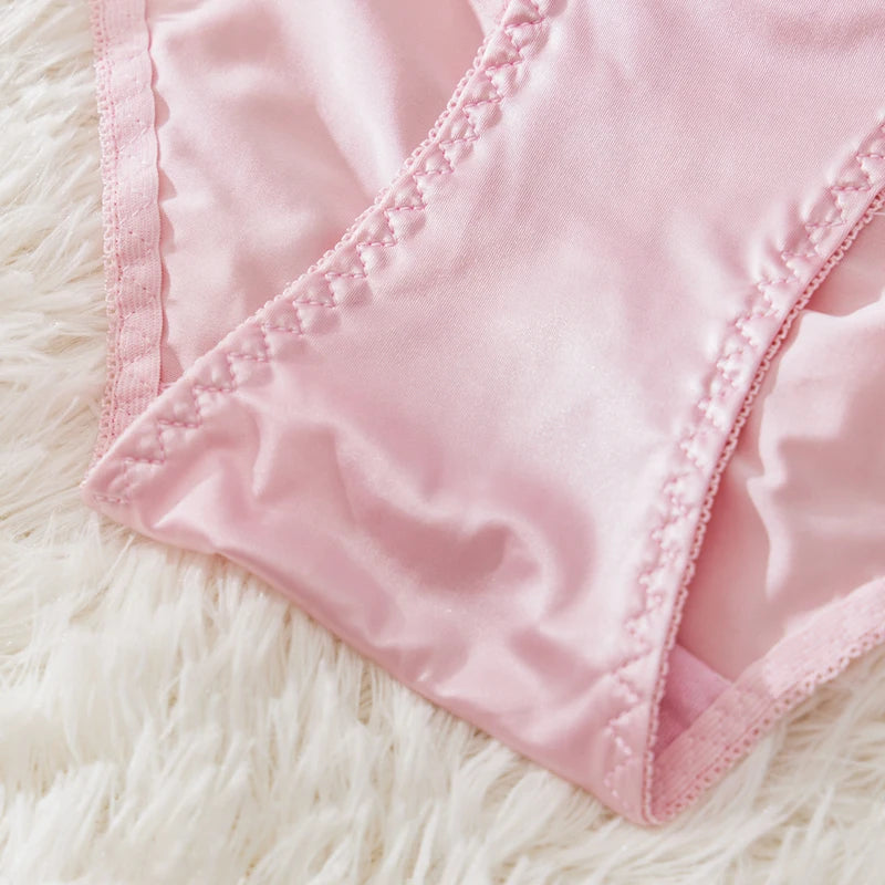 Close-up of a pink fabric with a textured surface on a fluffy white background