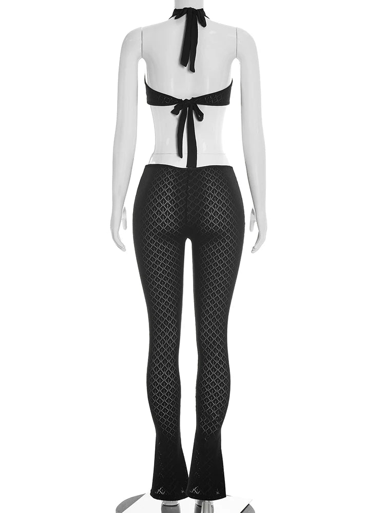 Mannequin wearing a black and white outfit with a bow detail on a white background