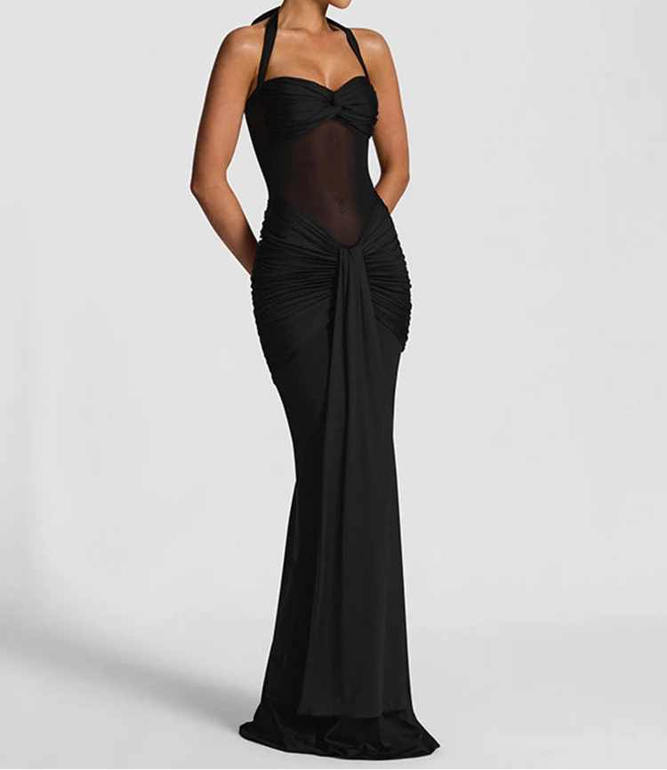 Black evening gown with sheer details on a white background