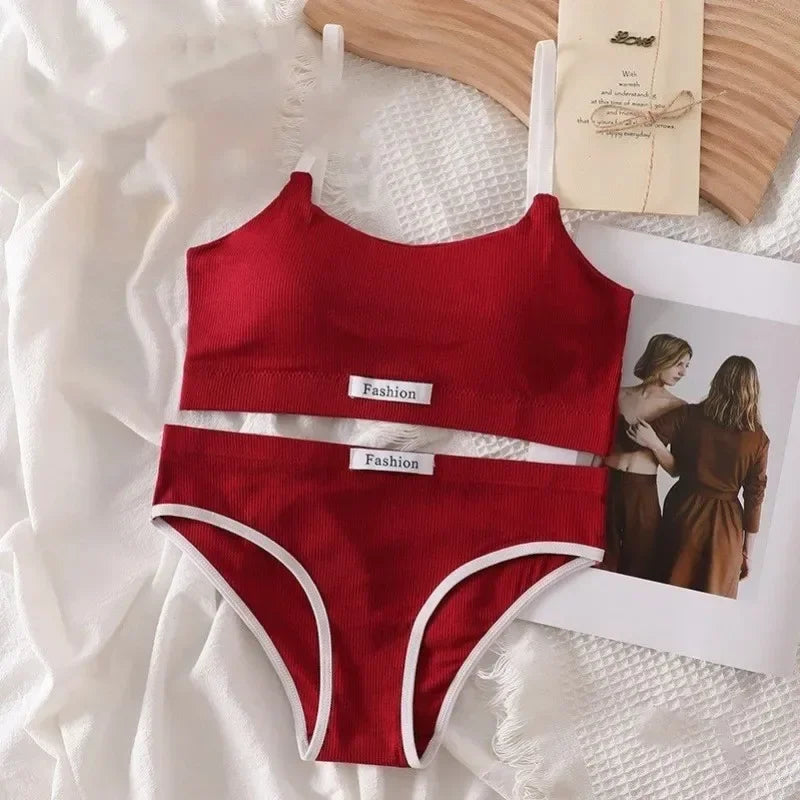 Red swimsuit with white trim on a textured surface