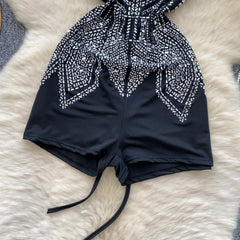 Black and white patterned swim top on a fluffy white surface