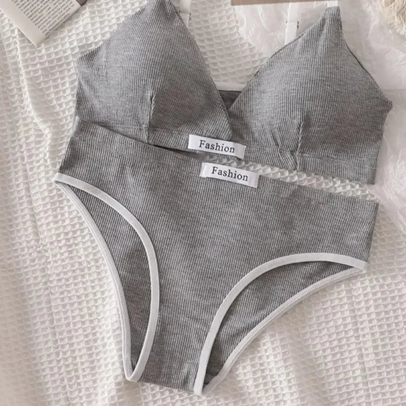 Gray women's underwear set with 'Fashion' labels on a textured white surface