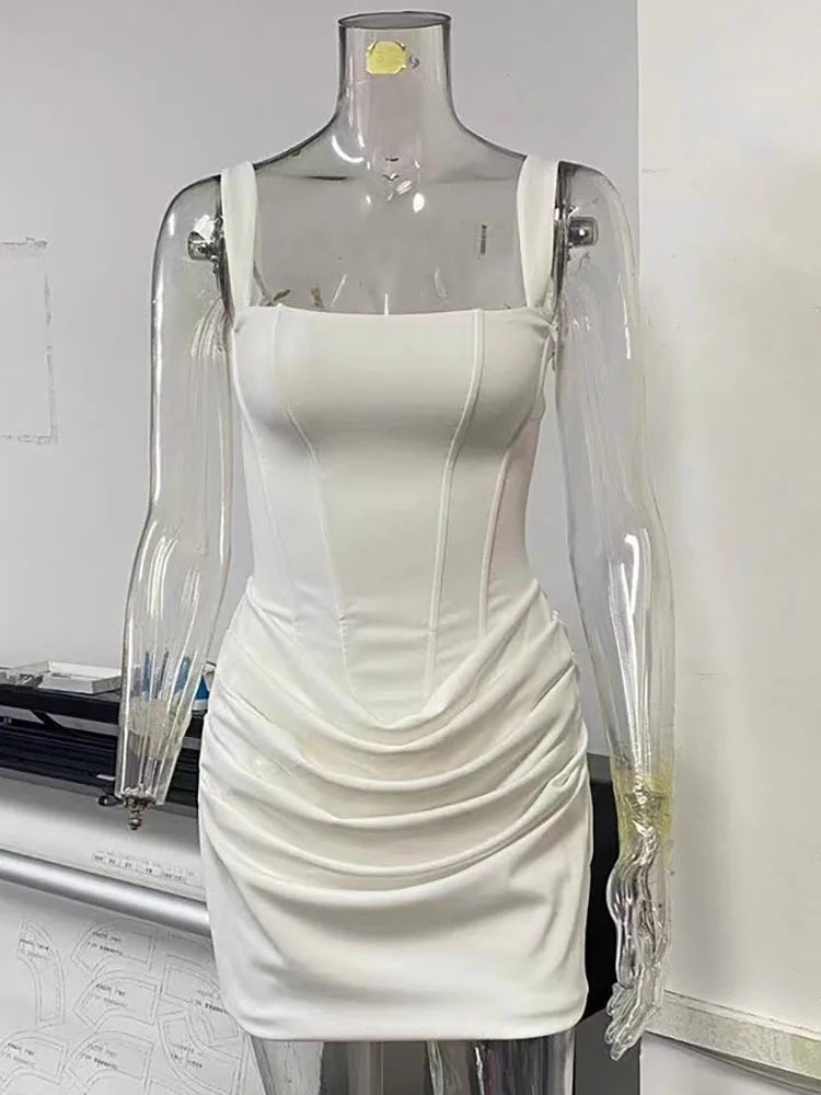 White dress on a transparent mannequin against a plain background