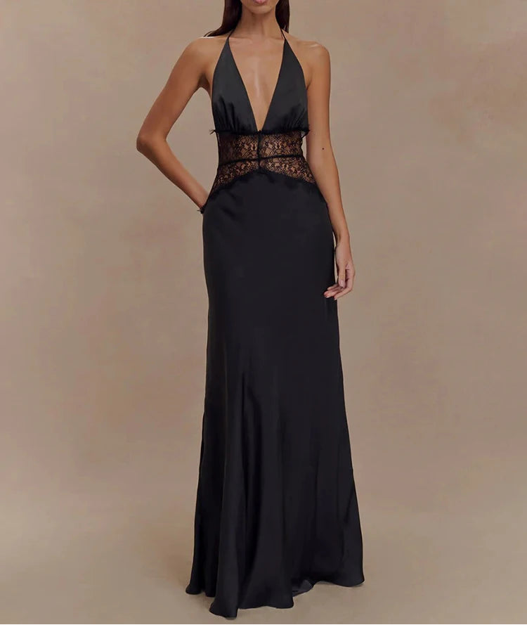 Woman wearing a black evening gown with a deep neckline on a beige background