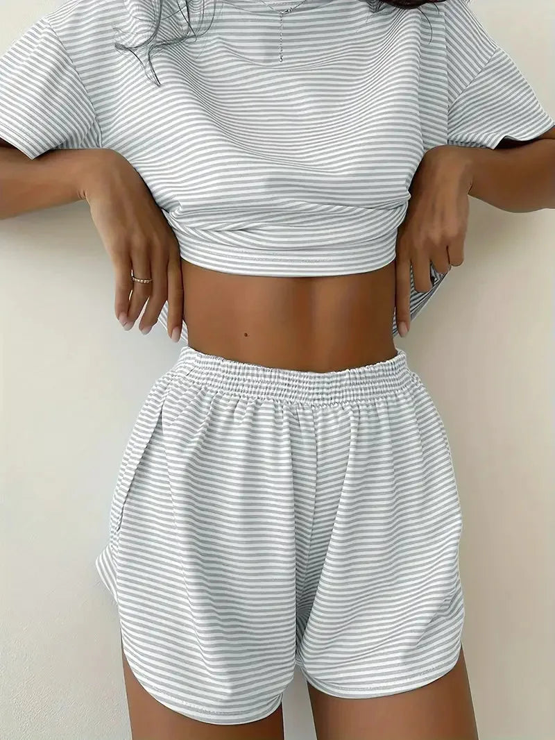 Person wearing a matching striped crop top and shorts set on a plain background