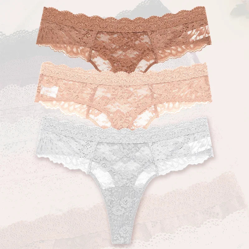 Set of three lace underwear pieces in different colors on a textured background