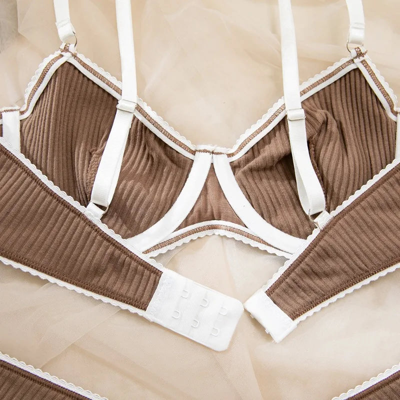 Brown ribbed bra and panties set with white straps on a beige background