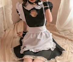 Person wearing a black and white maid outfit with a cat design.
