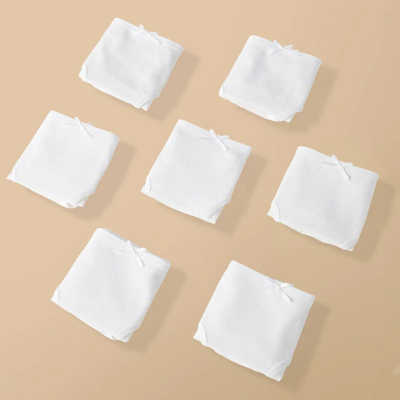 White square cloths arranged on a beige background