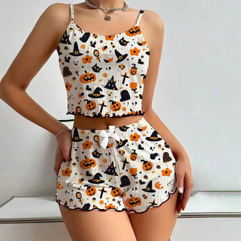 Two-piece Halloween-themed outfit with pumpkins, cats, and witch hats on a white background.