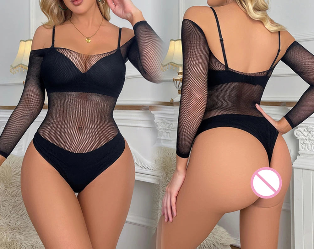 Woman wearing a black mesh bodysuit in a room with decorative elements.