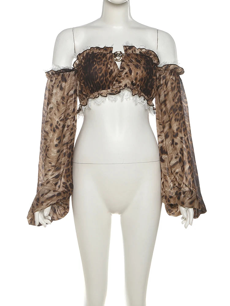 Mannequin wearing a leopard print top with sheer sleeves on a white background