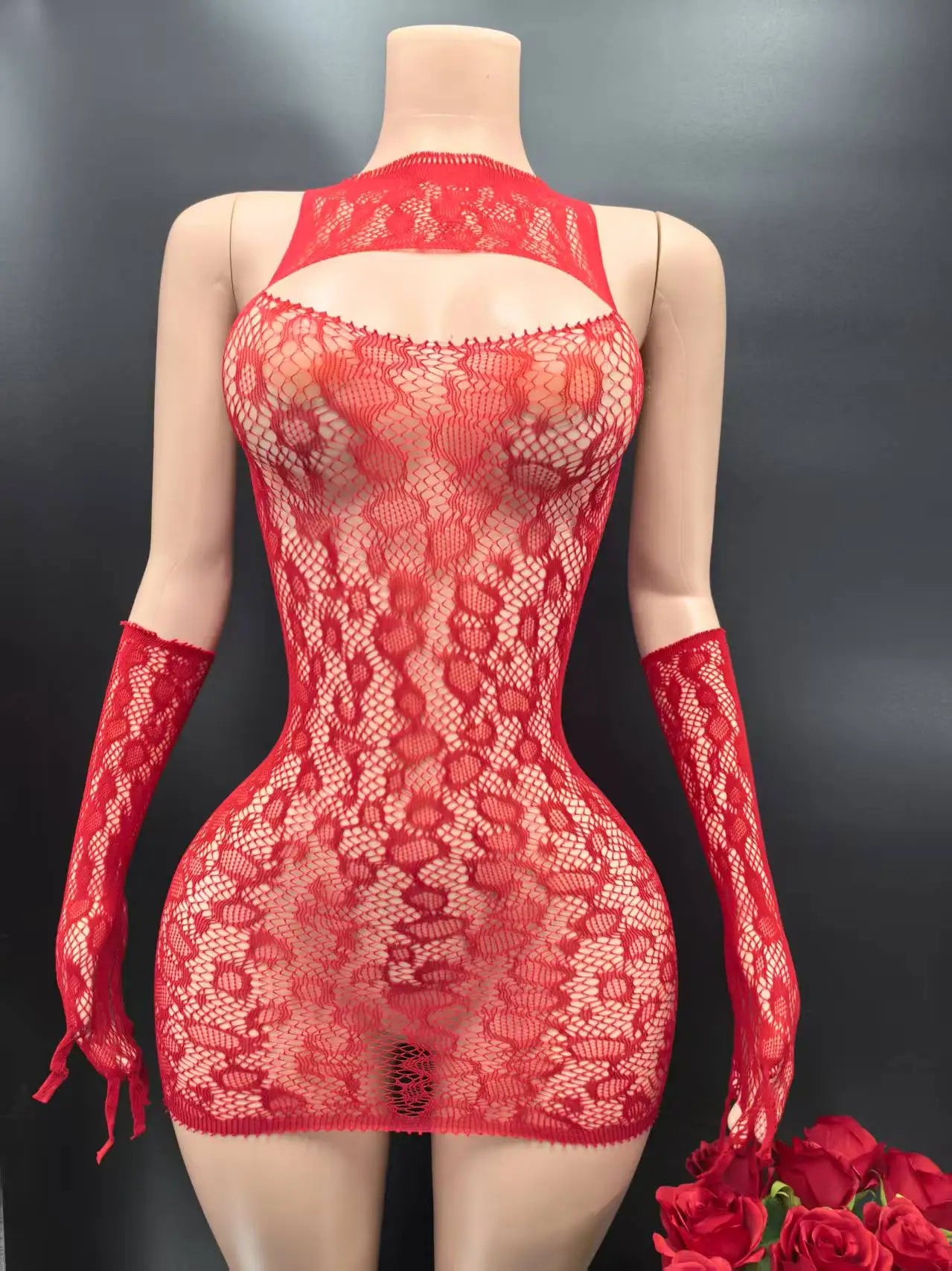 Red lace lingerie set with matching gloves on a mannequin against a dark background.