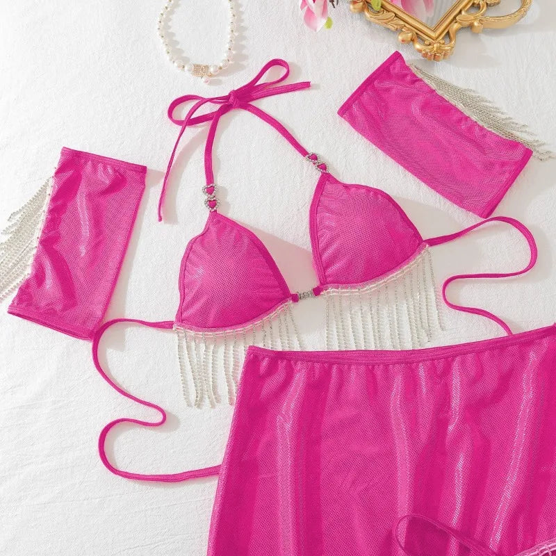 Pink bikini set with matching accessories on a white background