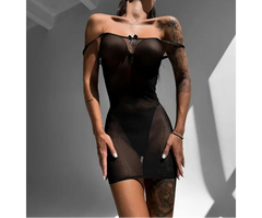 Woman wearing a black lace lingerie set against a neutral background