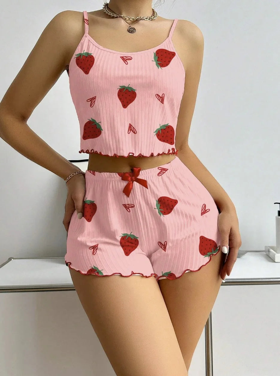Person wearing a pink pajama set with strawberry pattern on a white background