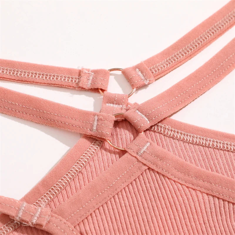 Close-up of a pink garment with straps on a white background