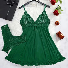 Green lace nightgown with matching bralette on a white surface with decorative items.