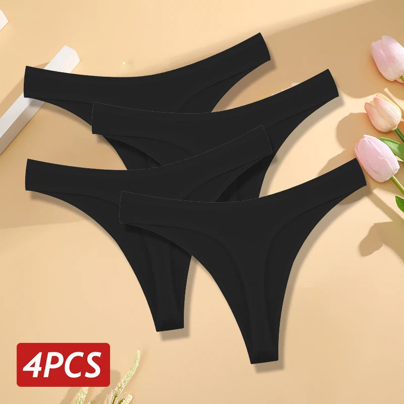 Four black thongs on a beige background with pink flowers.