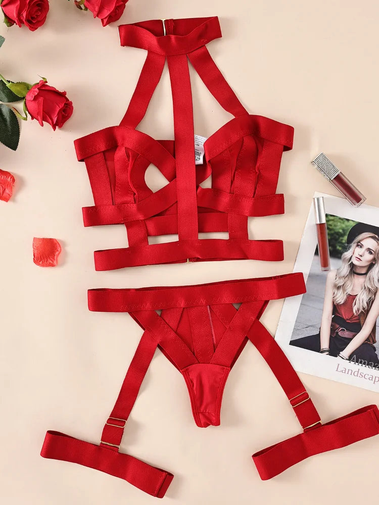 Red satin lingerie set on a beige background with roses and a magazine.