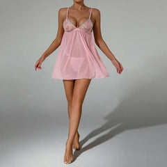Pink babydoll dress worn by a model on a gray background