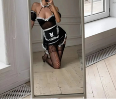 Person wearing a black and white maid outfit taking a mirror selfie.