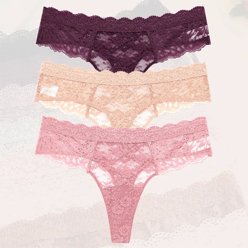 Three pairs of lace underwear in purple, pink, and peach on a textured white background.
