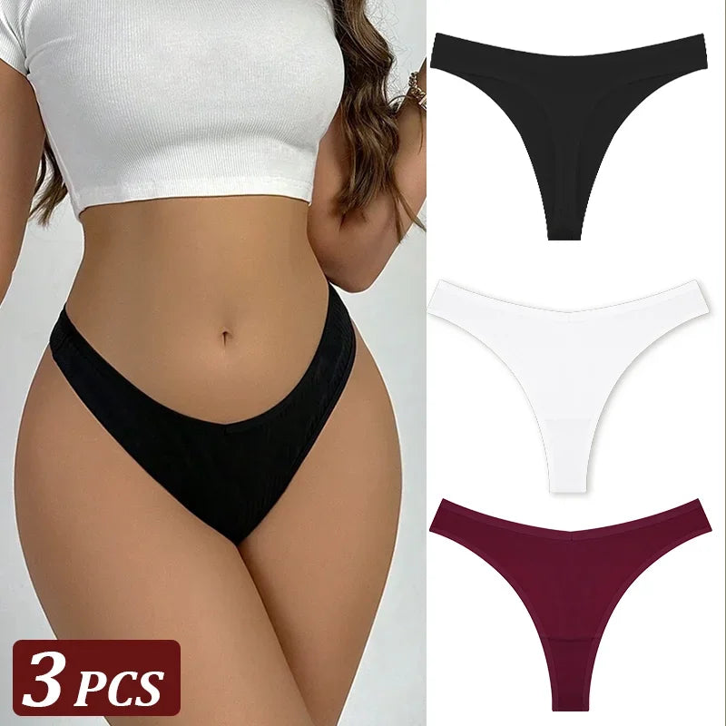 Black thong with additional options in white and burgundy on a plain background