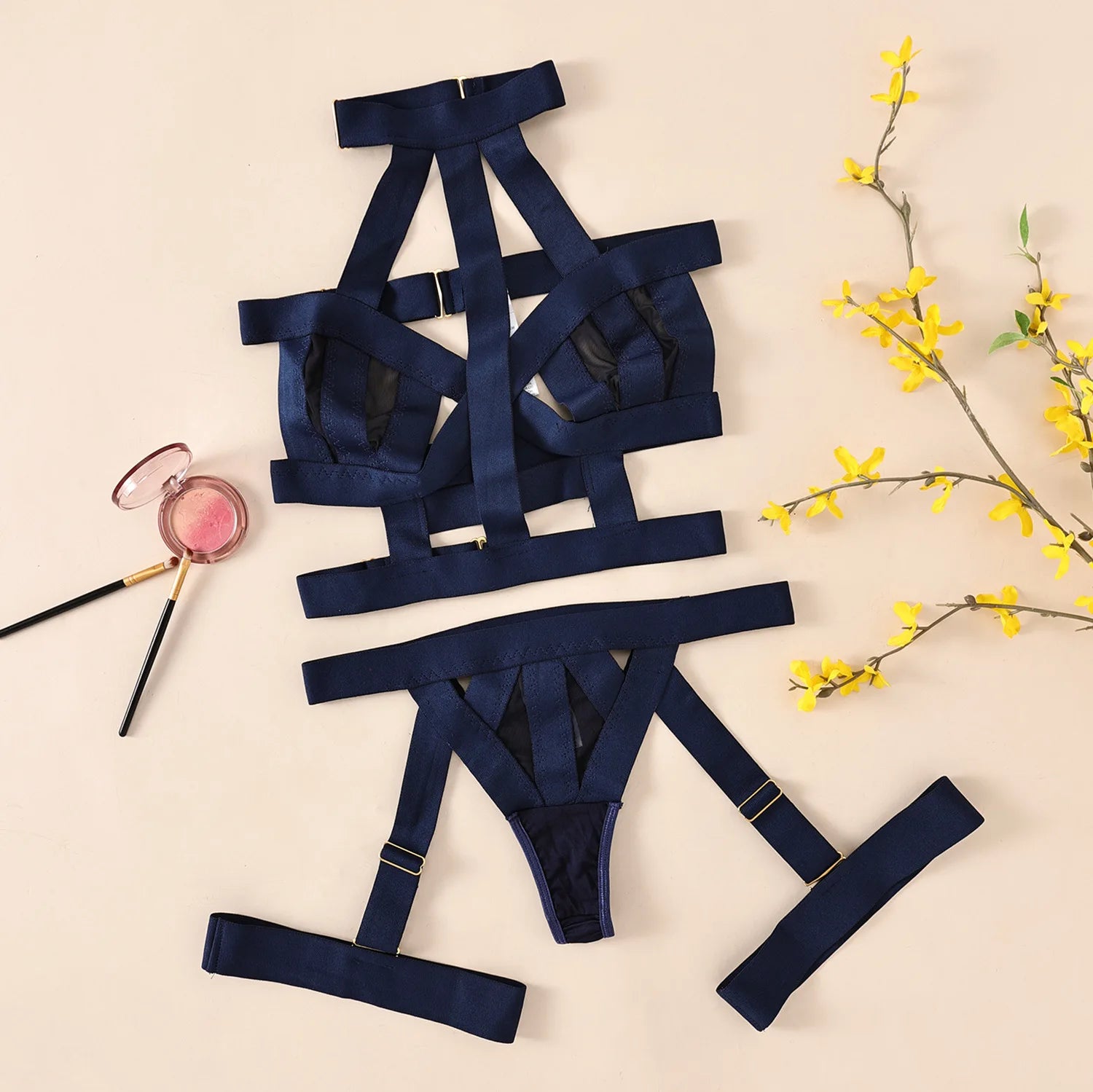 Navy blue lingerie set with accessories on a beige background