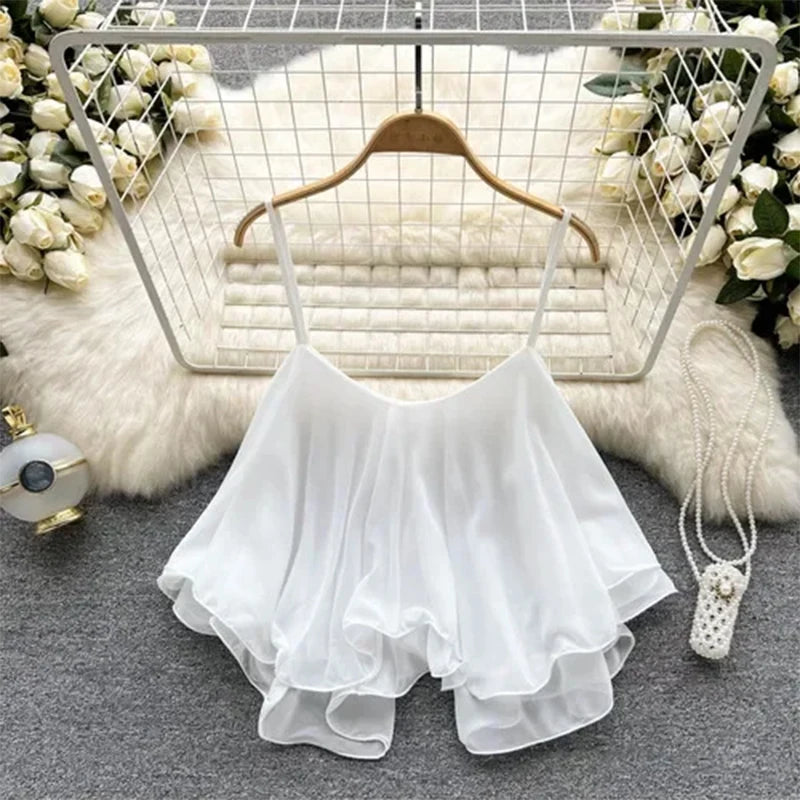White lace top on a hanger with decorative background