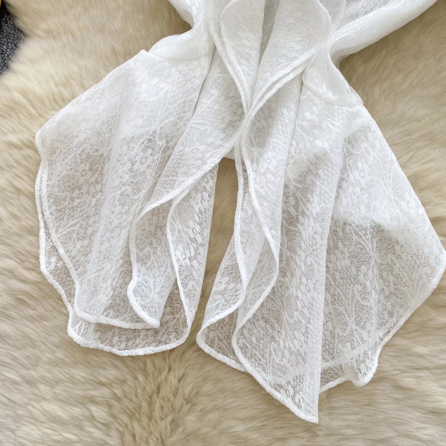 White lace fabric on a fur surface