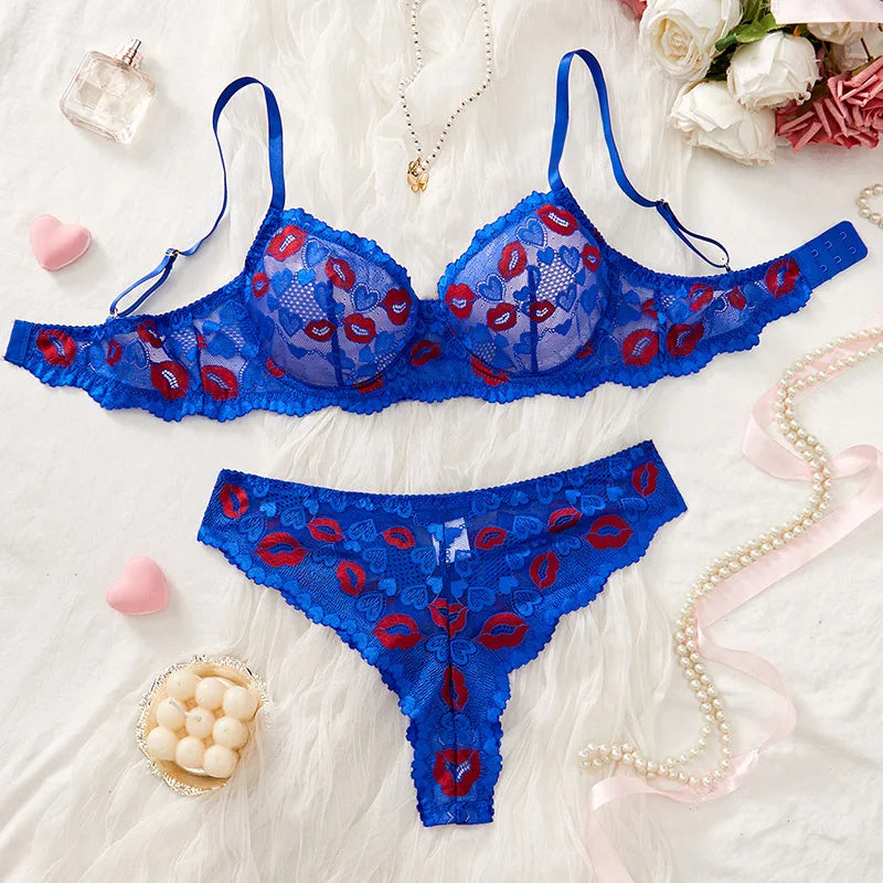 Blue lace lingerie set with red accents on a white background