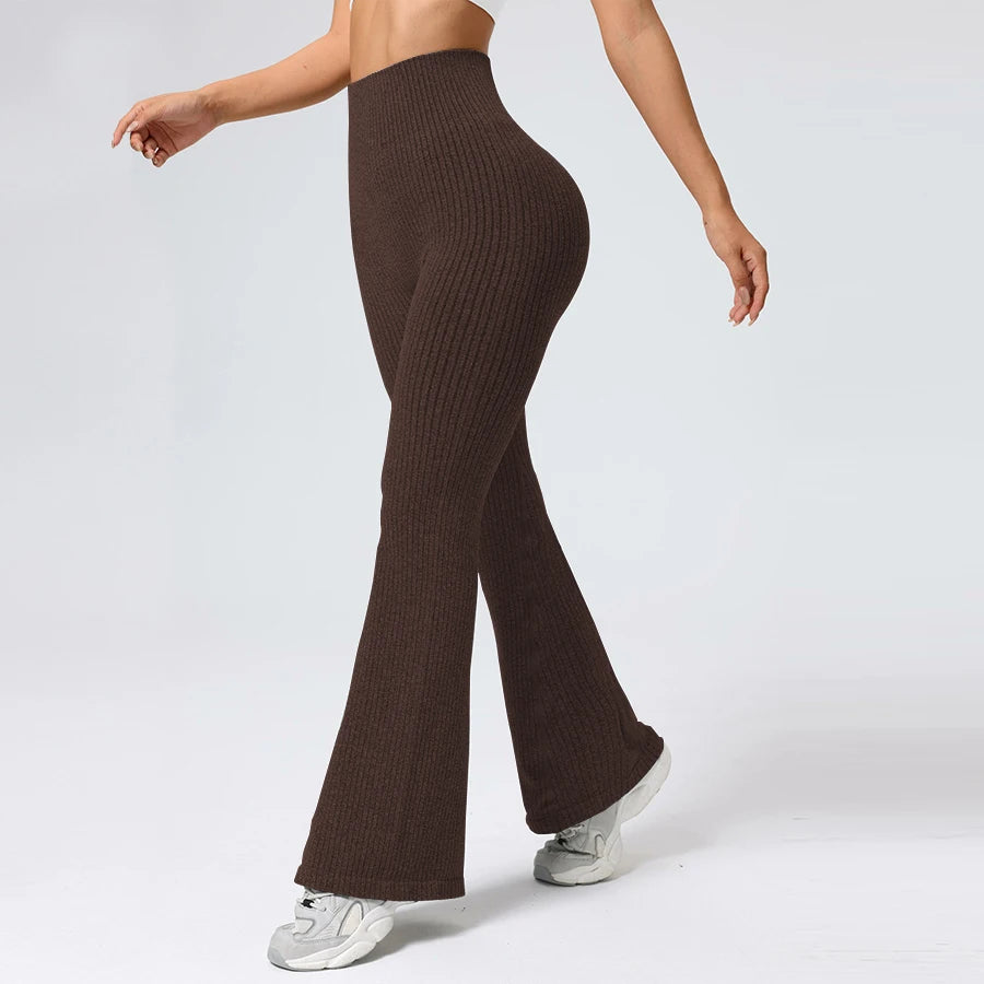 Brown ribbed knit pants worn by a person on a white background